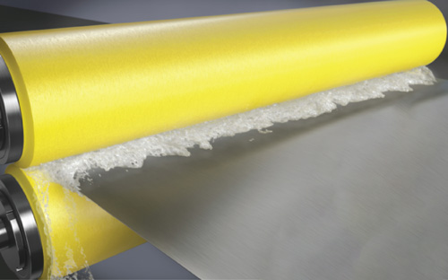 A pair of NCCM<sup>®</sup> Premier Yellow nonwoven rolls wringing fluid from a metal strip.