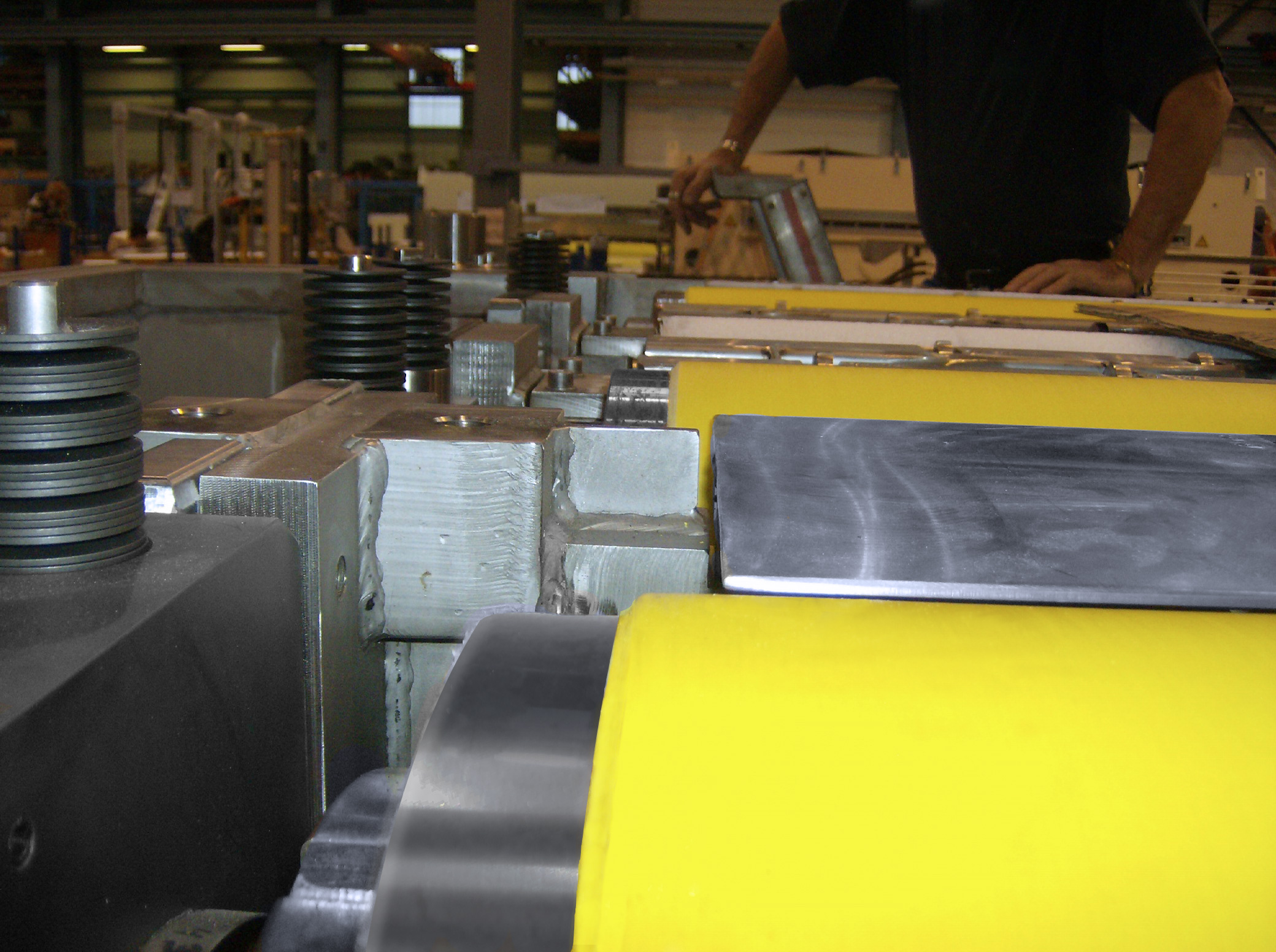 NCCM<sup>®</sup> Premier Yellow rolls in an open machine at a shop with the shop operator standing by