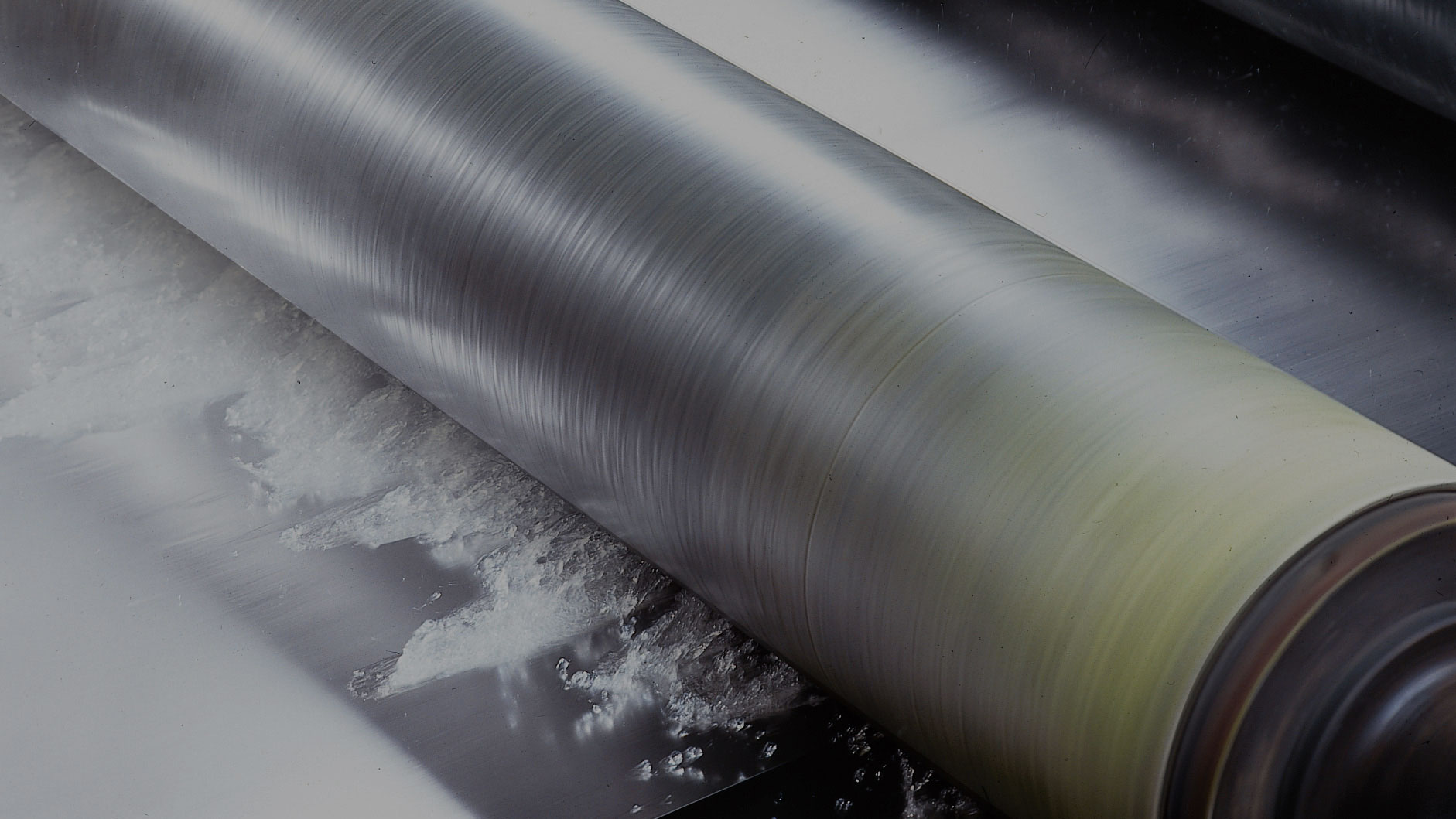 NCCM<sup>®</sup> Premier Yellow nonwoven roll controlling fluid on a metal blank