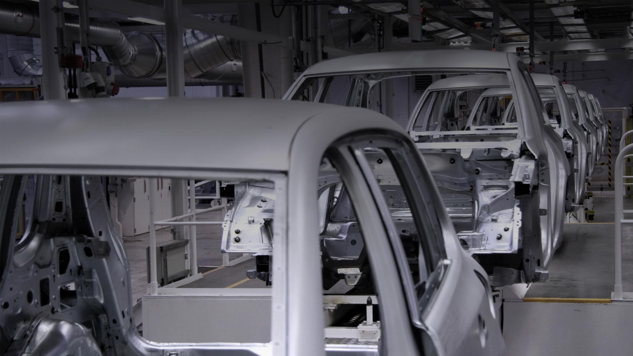An assembly line carrying automotive frames in a line