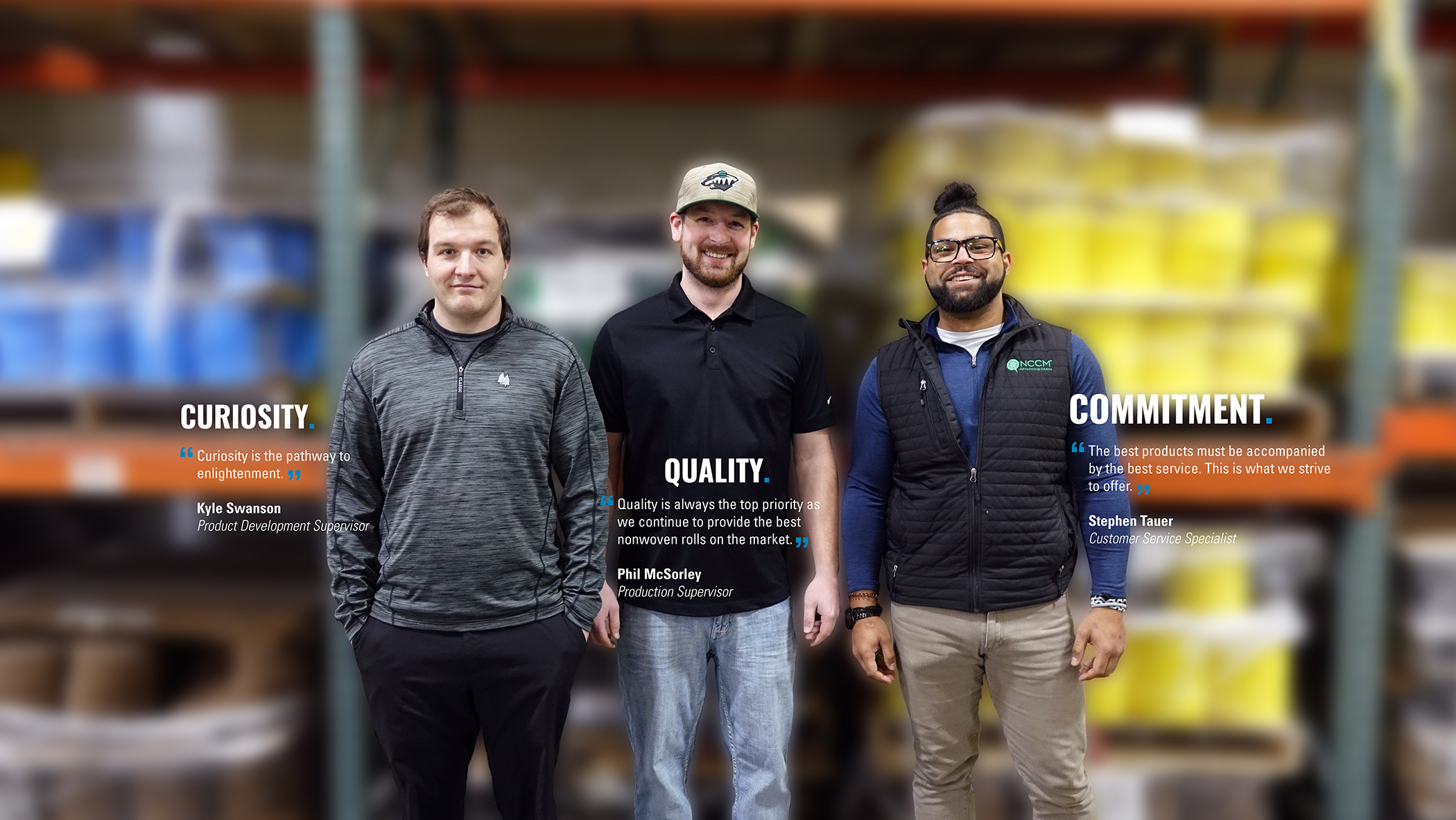 Three NCCM employees smiling and standing together in the plant.